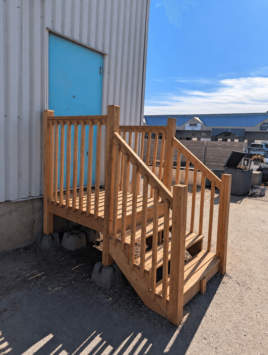 Rebuilt exterior wood stairs and railing, sanded and refinished in natural wood tone